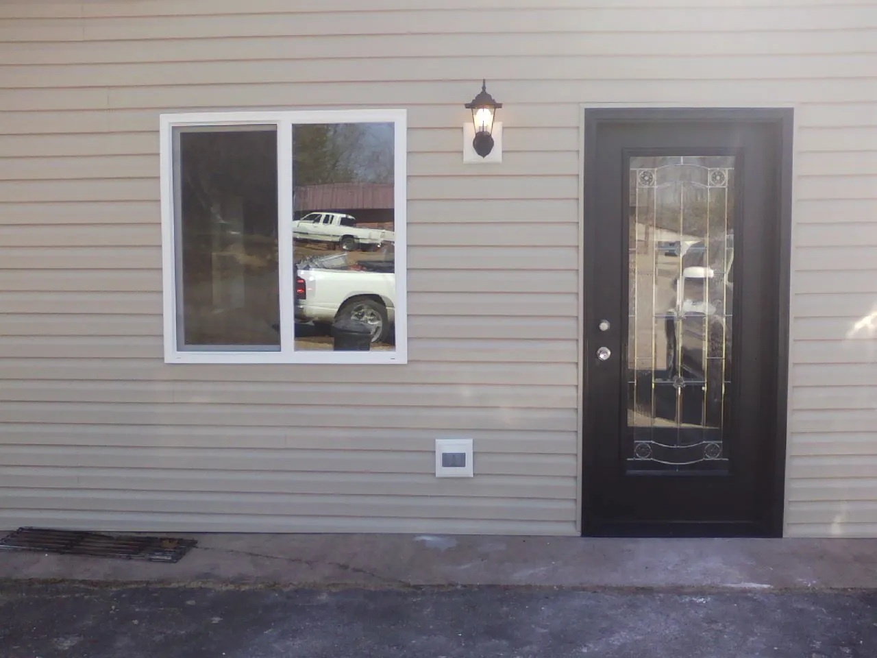 New siding, window and entry door on the side of an addition in Mountain Top
