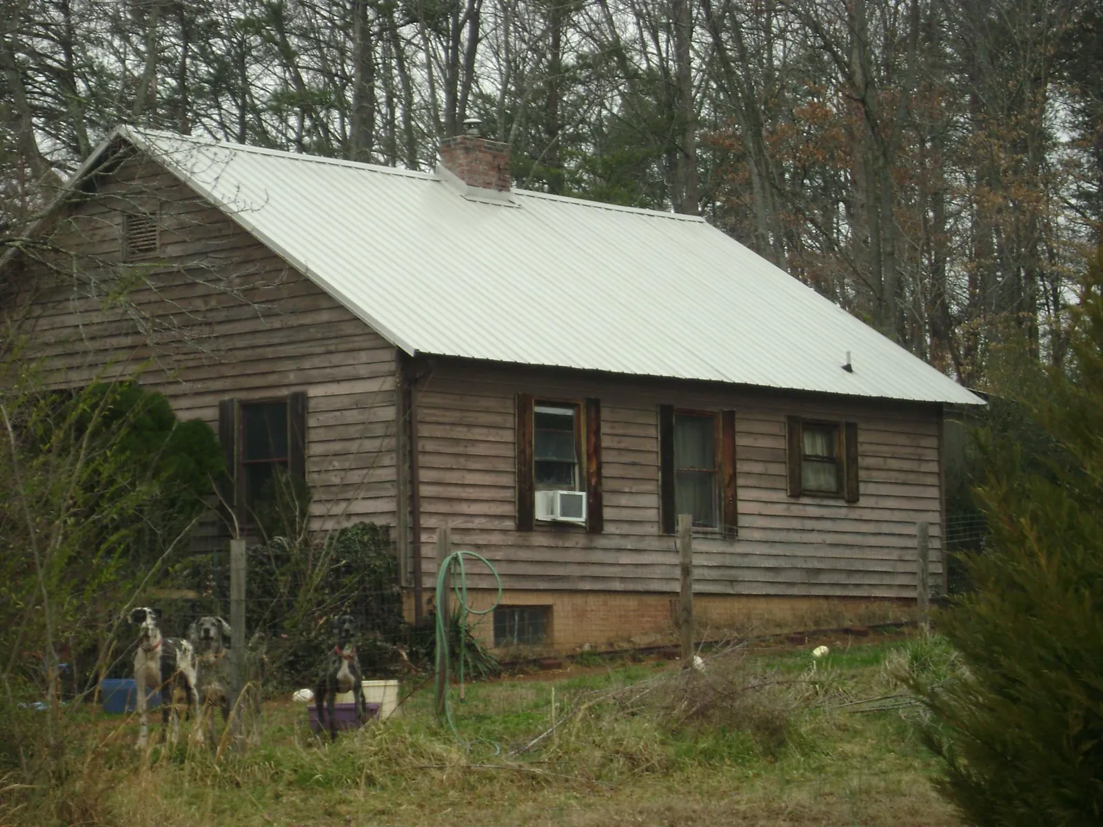 White metal roof on an old wood sided farmhouse, from a Metal Roof Installation job in Mountain Top